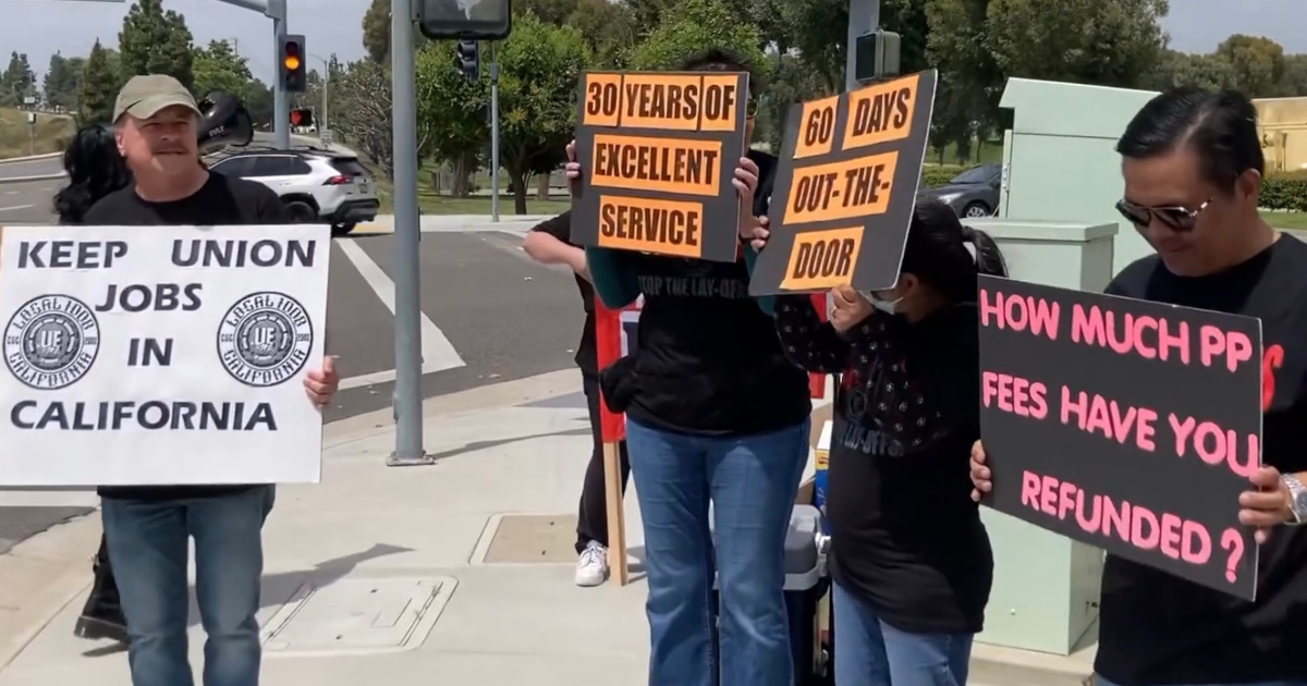 UE Local 1008 members with signs reading Keep Union Jobs in California, 30 Years of Excellent Service 60 Days Out-the-Door and How Much PP Fees Have You Refunded?