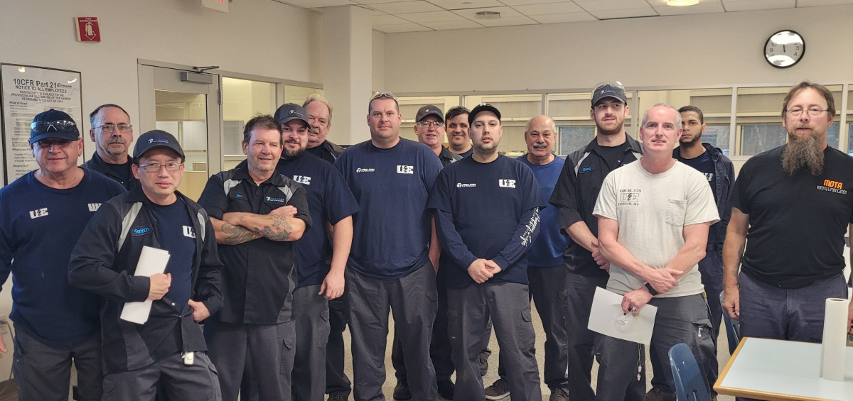 Fifteen workers, many of them wearing UE t-shirts