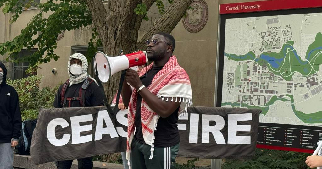 Momdou Taal speaking at a peaceful protest demanding a ceasefire in Gaza