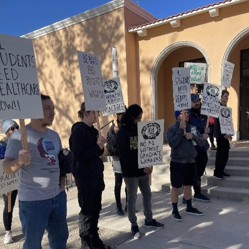 UE Local 1498 members standing outside with picket signs.