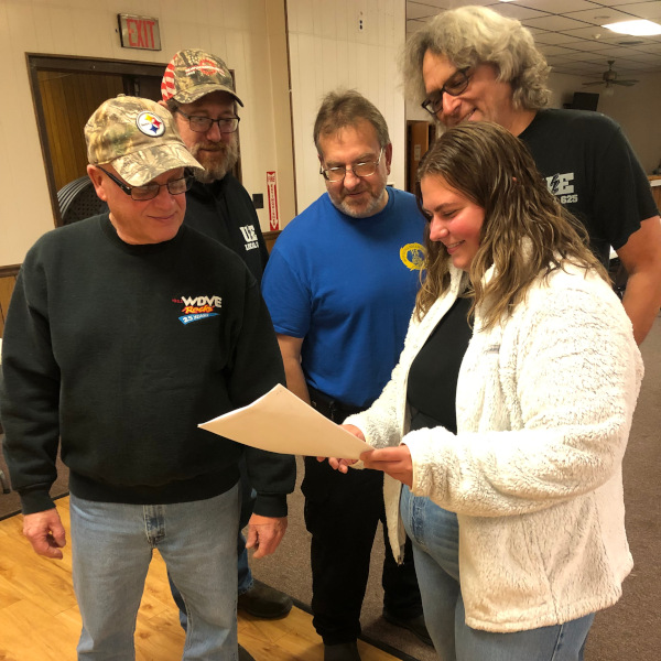 Four men and a woman looking at some papers