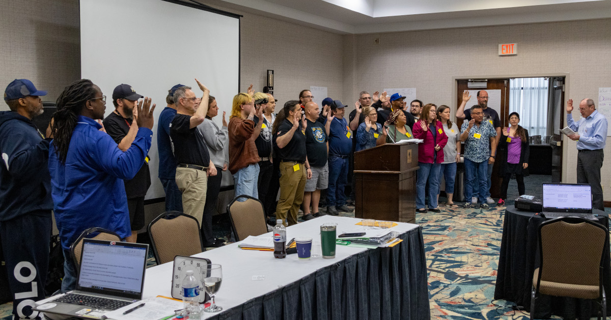 Approximately two dozen UE leaders being sworn in to their offices