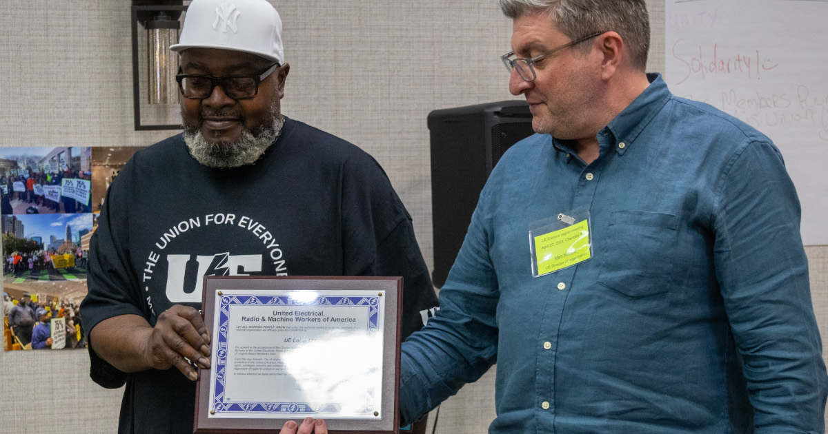 UE Director of Organization Mark Meinster presenting a charter for UE Local 111 to Local 111 President Terry Green